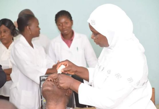 Matron of the Clinic, Mrs Olubunmi Lawal, demonstrating to the patients how to administer eye drops